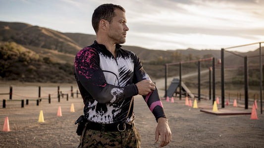Military member adjusting performance uniform sleeve outdoors