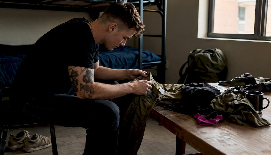 Service member inspecting barracks casual clothing at desk
