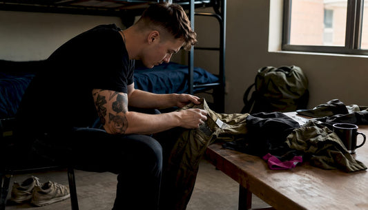 Service member inspecting barracks casual clothing at desk