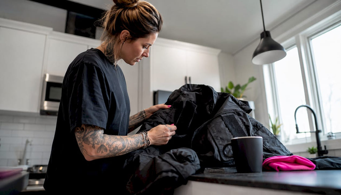 Veteran woman examining tactical jacket thoughtfully