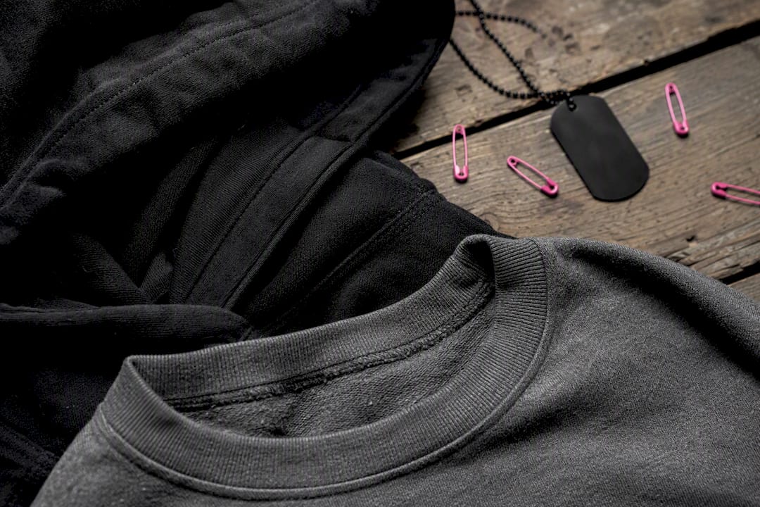 Partial crewneck and hoodie fabric details flat lay