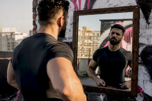 Muscular man adjusting athletic shirt fit