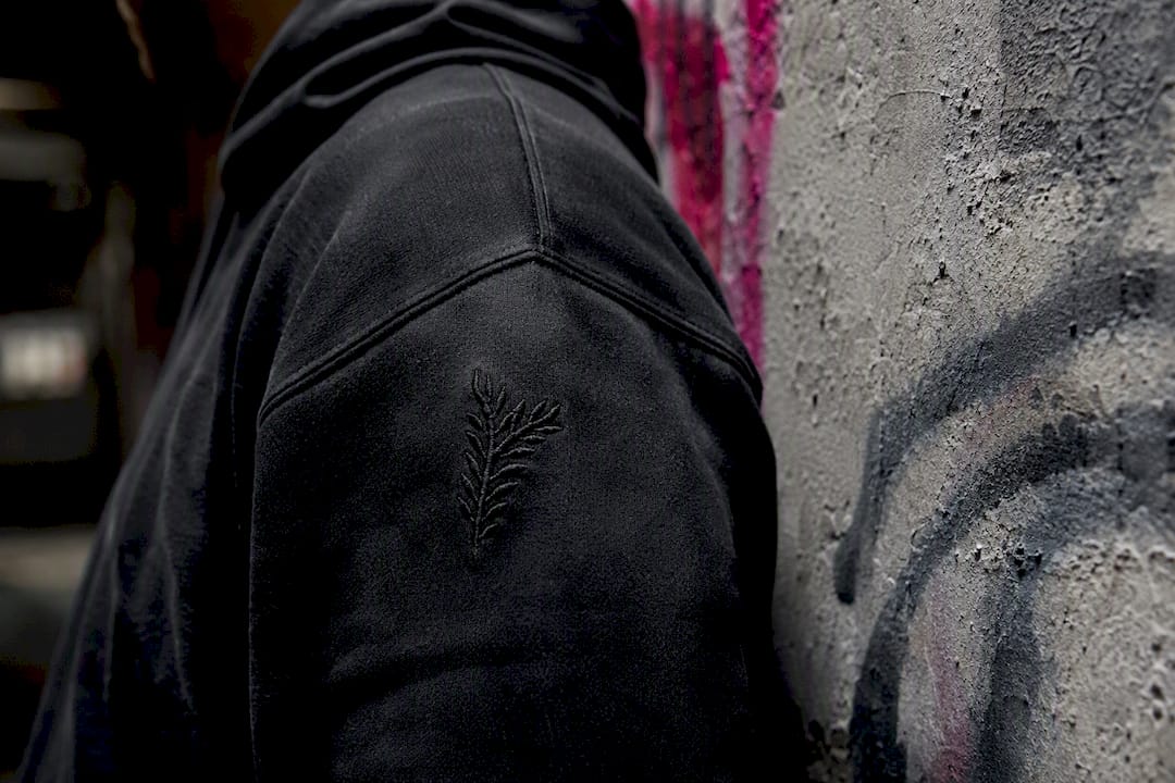 Close-up shoulder detail of tactical hoodie fabric