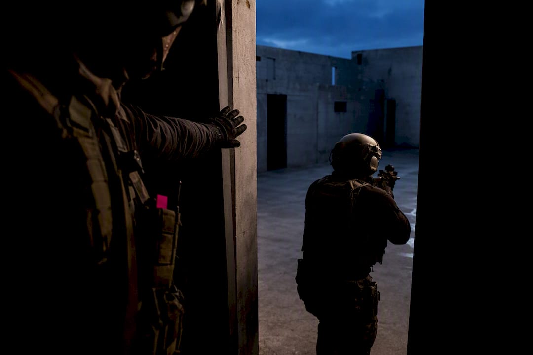 Military personnel coordinating movement under pressure