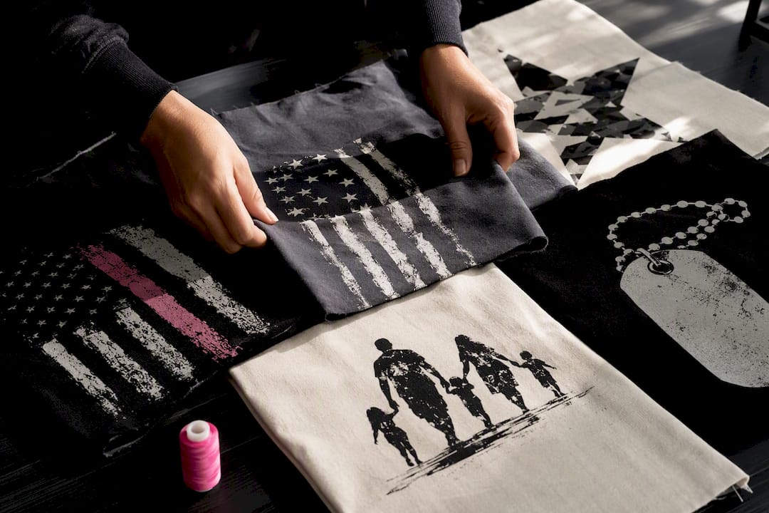 Hands arranging military spouse shirt design swatches