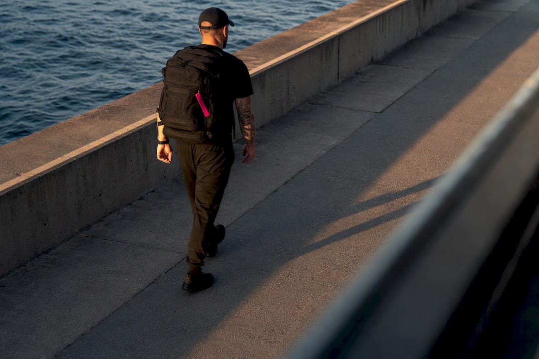 Veteran walking with loaded rucksack
