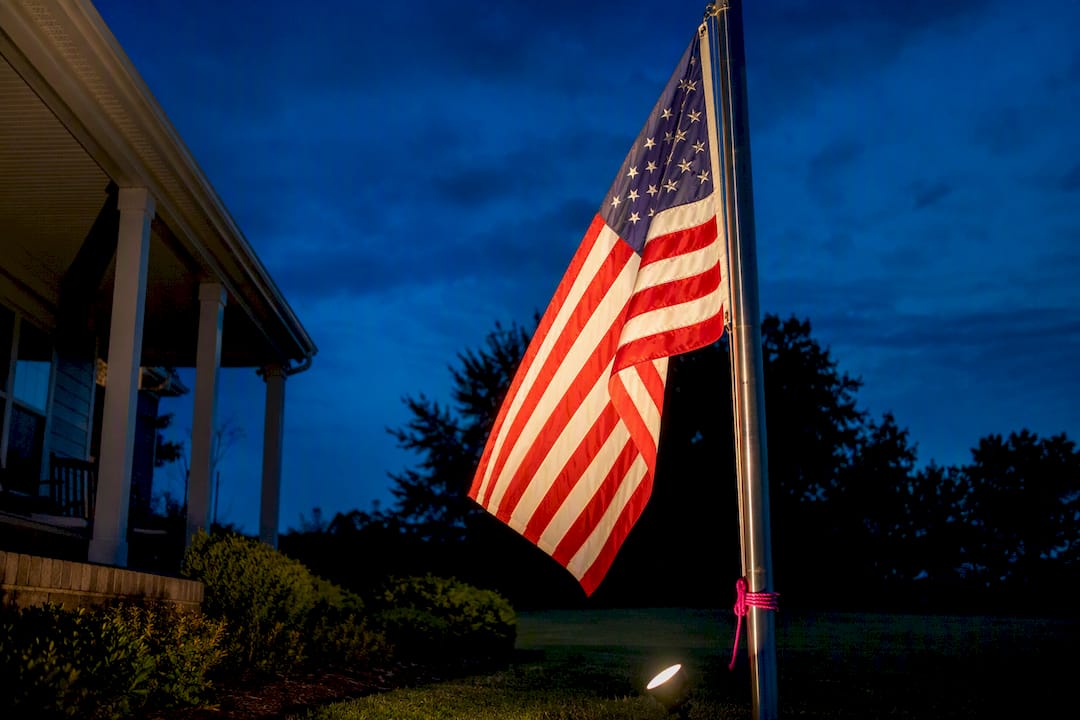 American flag illuminated after sunset