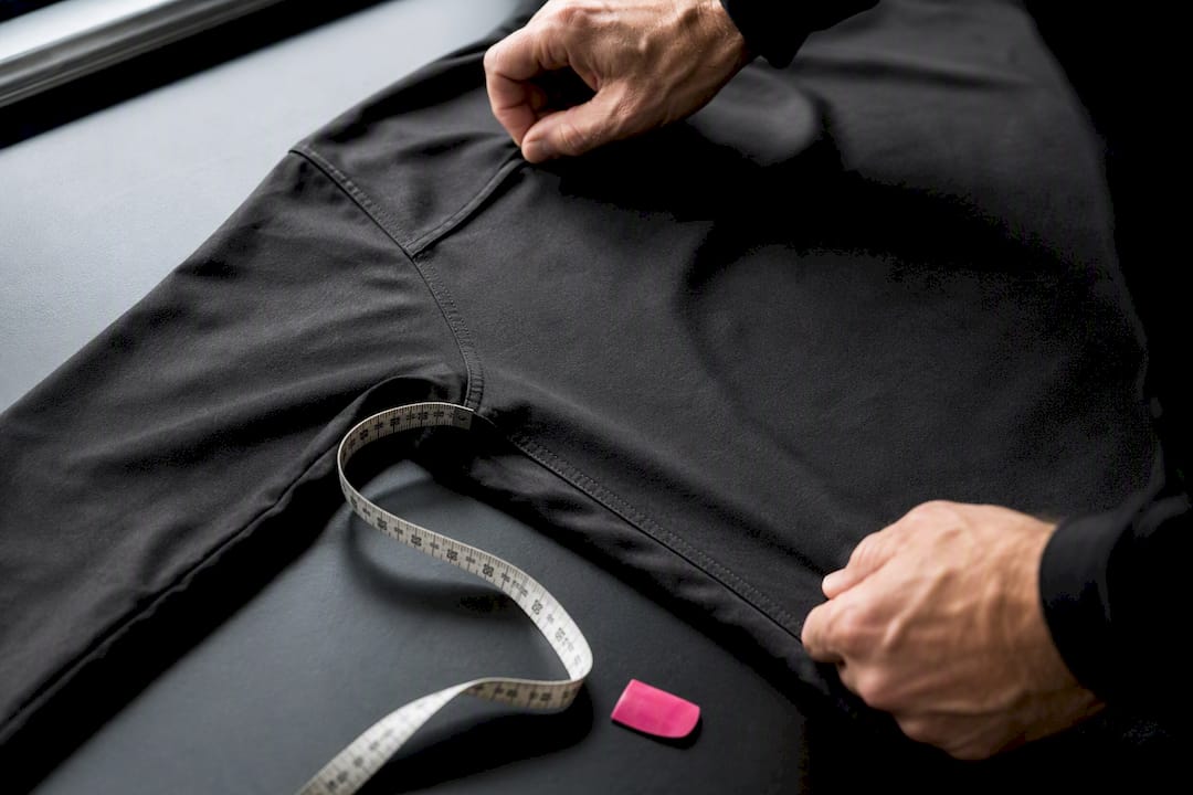 Hands measuring shirt fit points