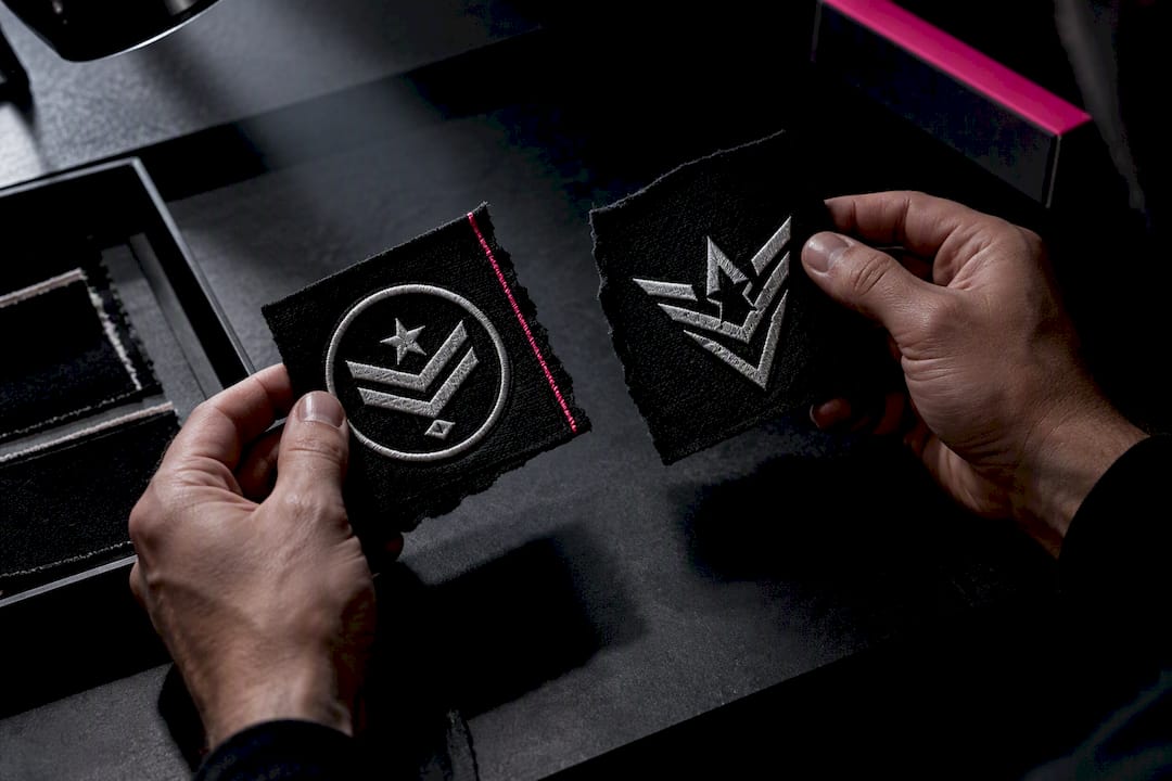 Hands comparing official and commercial symbol fragments