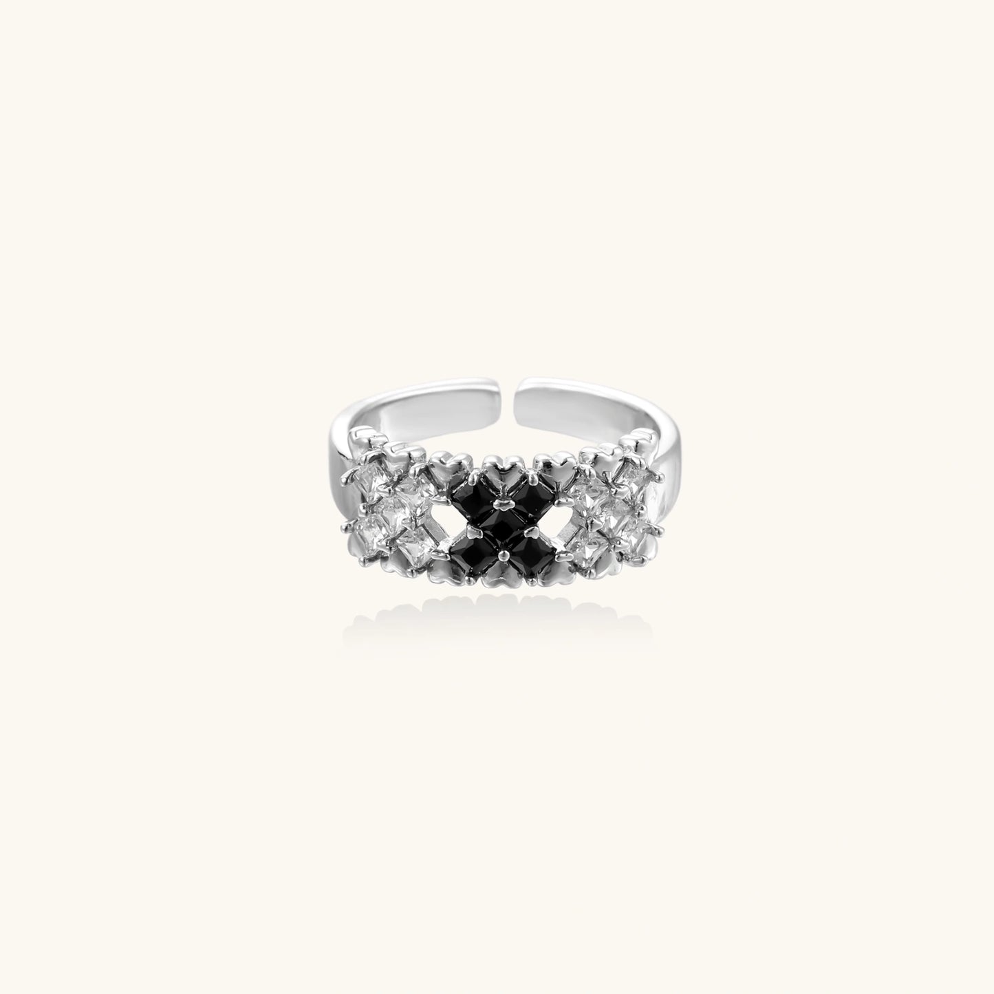 Adjustable white gold plated ring with geometric grid of black and clear zirconia stones in checkerboard pattern