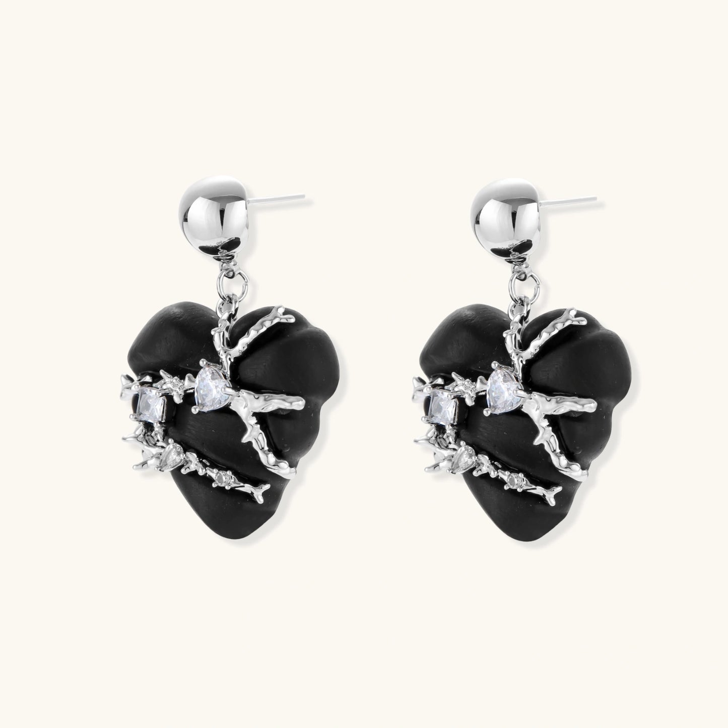 Black heart-shaped wood earrings with decorative silver chains and crystal accents hanging from silver ball studs